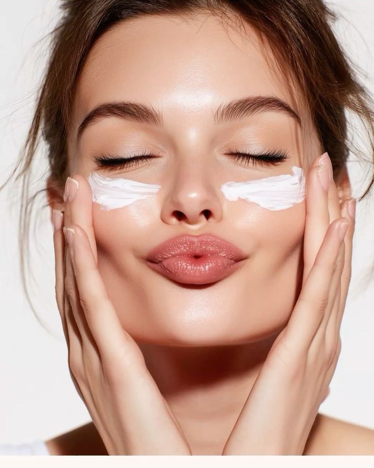 Applying skincare cream to the face
